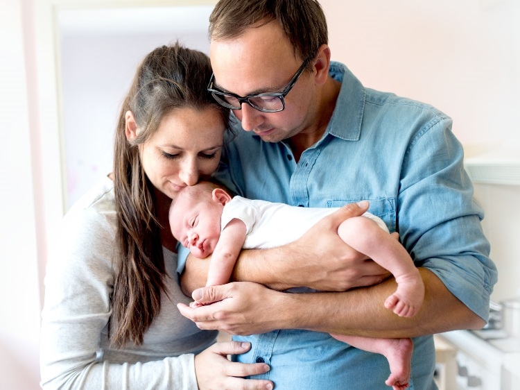 happy heterosexual couple with baby